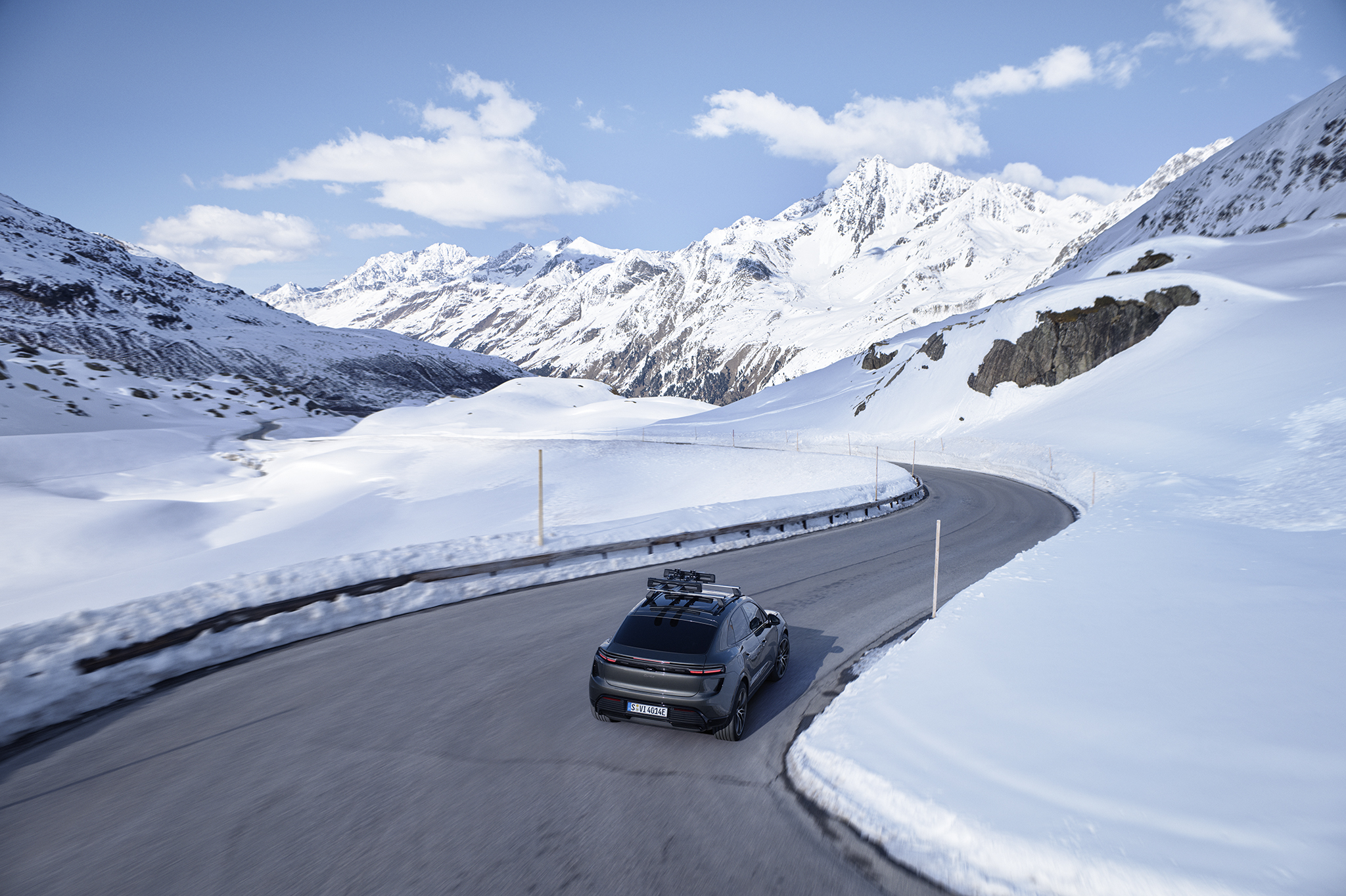 Porsche Cayenne con portaequipajes de techo en carretera de montaña nevada